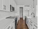 Bright kitchen features white cabinets, stainless steel appliances, tile backsplash, and hardwood floors at 210 Goldenrod Cir, Salisbury, NC 28147