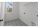 Laundry room with patterned tile flooring and built-in shelf at 210 Goldenrod Cir, Salisbury, NC 28147