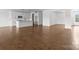 Spacious living room featuring hardwood floors, white walls, and seamless flow into kitchen area at 210 Goldenrod Cir, Salisbury, NC 28147