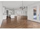 Open-concept living room with hardwood floors, neutral walls, and modern lighting at 210 Goldenrod Cir, Salisbury, NC 28147