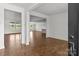 Open-concept living room with hardwood floors, white walls, and natural light from the large front windows at 210 Goldenrod Cir, Salisbury, NC 28147