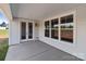 Covered patio featuring a concrete floor, exterior lights, and double doors leading to the interior at 210 Goldenrod Cir, Salisbury, NC 28147