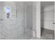 Modern shower with marble tile, glass door, and a built-in bench at 210 Goldenrod Cir, Salisbury, NC 28147