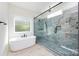 This bright bathroom features a glass shower with tile surround, and a soaking tub near the window at 240 Doster Rd, Lancaster, SC 29720