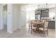 Bright dining area featuring a round table, hardwood floors and opens to a modern gray kitchen at 240 Doster Rd, Lancaster, SC 29720