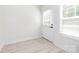 Bright entryway featuring hardwood floors and a white door with blinds on both the door and window at 240 Doster Rd, Lancaster, SC 29720