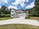 Attractive home with white siding, a large driveway, and an attached garage at 240 Doster Rd, Lancaster, SC 29720