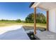 Welcoming covered front porch with wood columns and a concrete walkway, offering a charming entrance to the home at 240 Doster Rd, Lancaster, SC 29720