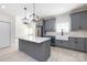 Bright kitchen with a large island, gray cabinetry, and modern pendant lighting at 240 Doster Rd, Lancaster, SC 29720