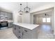 Open-concept kitchen with a large island, gray cabinetry, and access to the living area at 240 Doster Rd, Lancaster, SC 29720