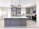 Modern kitchen featuring gray cabinets, a large island, and stainless steel appliances at 240 Doster Rd, Lancaster, SC 29720
