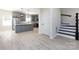 Open kitchen with gray cabinets, white countertops, stainless steel appliances, and hardwood floors at 240 Doster Rd, Lancaster, SC 29720