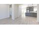 Bright open-concept living room with hardwood floors, white walls, and views of the gray kitchen at 240 Doster Rd, Lancaster, SC 29720