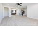 Open-concept living room that opens to a kitchen with hardwood floors and black stair railing at 240 Doster Rd, Lancaster, SC 29720