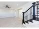 Bright living room featuring stylish staircase, light wood flooring, and a modern ceiling fan at 240 Doster Rd, Lancaster, SC 29720