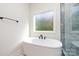 This bright bathroom features a soaking tub and window at 240 Doster Rd, Lancaster, SC 29720