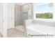 Well-lit bathroom features a glass-enclosed shower, separate soaking tub, and modern fixtures at 2416 Morgan Hills Dr # 297P, Albemarle, NC 28001