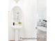 Modern powder room features a pedestal sink, an oval mirror, and hardwood floors leading to an adjacent office space at 2416 Morgan Hills Dr # 297P, Albemarle, NC 28001