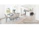 Dining room with a chandelier, large windows, and views into the kitchen featuring an island with seating and white cabinets at 2416 Morgan Hills Dr # 297P, Albemarle, NC 28001