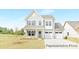 Charming two-story home with stone accents, a welcoming porch, a two-car garage, and manicured front lawn at 2416 Morgan Hills Dr # 297P, Albemarle, NC 28001