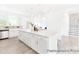 Spacious kitchen boasts a large island with seating, stainless steel appliances, and ample counter space, opening to living area at 2416 Morgan Hills Dr # 297P, Albemarle, NC 28001