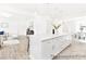 Well-lit open concept kitchen with a large island, hardwood floors, stainless appliances and views into the dining and living area at 2416 Morgan Hills Dr # 297P, Albemarle, NC 28001
