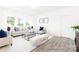 Bright living room with hardwood floors, neutral furniture, and large windows providing natural light and views of the outdoors at 2416 Morgan Hills Dr # 297P, Albemarle, NC 28001