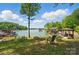 Serene backyard with lake views, featuring a seating area and gazebo perfect for outdoor enjoyment at 2501 Mt Isle Harbor Dr, Charlotte, NC 28214