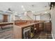 A stylish bar area in the game room with wood finishes, sink, mini-refrigerator, and custom lighting at 2501 Mt Isle Harbor Dr, Charlotte, NC 28214