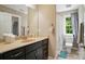 Bathroom featuring dark cabinets, ample counter space, and a shower/tub combo with natural light at 2501 Mt Isle Harbor Dr, Charlotte, NC 28214