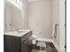 Bathroom with vanity and dark wood cabinets and countertop sink, and toilet off to the side at 2501 Mt Isle Harbor Dr, Charlotte, NC 28214
