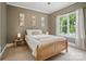 Comfortable bedroom features soft, neutral colors, cozy bed, and a window with natural light at 2501 Mt Isle Harbor Dr, Charlotte, NC 28214
