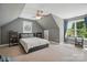 Cozy bedroom features a gray color scheme, sloped ceilings, and natural light from a window at 2501 Mt Isle Harbor Dr, Charlotte, NC 28214