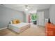 Bright bedroom featuring neutral colors, soft textures, and a large window for natural light at 2501 Mt Isle Harbor Dr, Charlotte, NC 28214