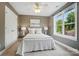 Relaxing bedroom features soft colors, warm lighting, and a large window with a green view at 2501 Mt Isle Harbor Dr, Charlotte, NC 28214