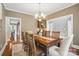 Inviting dining room featuring a wooden table with seating for six under an elegant chandelier at 2501 Mt Isle Harbor Dr, Charlotte, NC 28214