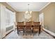 Traditional dining room with hardwood floors, large window, and seating for six, perfect for gatherings at 2501 Mt Isle Harbor Dr, Charlotte, NC 28214