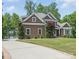 Desirable exterior of this lovely home with stone and wood, complemented by a long driveway at 2501 Mt Isle Harbor Dr, Charlotte, NC 28214