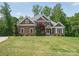 Charming exterior of this well-maintained home, featuring a lush green lawn and mature trees at 2501 Mt Isle Harbor Dr, Charlotte, NC 28214
