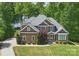 Beautiful two-story home with stone accents and a well-manicured lawn, nestled amongst mature trees at 2501 Mt Isle Harbor Dr, Charlotte, NC 28214