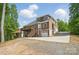 Two-story home boasts a welcoming exterior with a spacious deck, attached garage, and expansive driveway at 2501 Mt Isle Harbor Dr, Charlotte, NC 28214