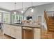 Spacious kitchen with an island sink, stainless steel dishwasher, and hardwood floors at 2501 Mt Isle Harbor Dr, Charlotte, NC 28214