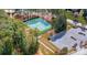 Aerial view of tennis courts surrounded by trees next to a parking lot at 2501 Mt Isle Harbor Dr, Charlotte, NC 28214