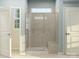 Bathroom showcases glass shower enclosure with seating, white fixtures, and natural light at 2806 Morning Song Way, Lancaster, SC 29720
