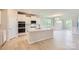 Modern kitchen with white cabinets, quartz countertops, a central island, and stainless steel appliances at 2806 Morning Song Way, Lancaster, SC 29720
