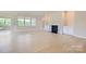 Bright, open-concept living room with elegant fireplace, mantle, and large windows offering scenic views at 2806 Morning Song Way, Lancaster, SC 29720
