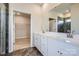 Main bathroom featuring double vanity, a large mirror, and a tiled shower at 2806 Morning Song Way, Lancaster, SC 29720
