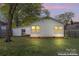 White home with an ample backyard, window views, and possible garage access on the side at 288 Fink Nw Ave, Concord, NC 28025