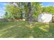 Spacious, partially fenced backyard with a storage shed, large tree, and ample green space at 288 Fink Nw Ave, Concord, NC 28025