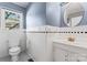 This bathroom features a classic design with a white sink, toilet, and round mirror at 288 Fink Nw Ave, Concord, NC 28025